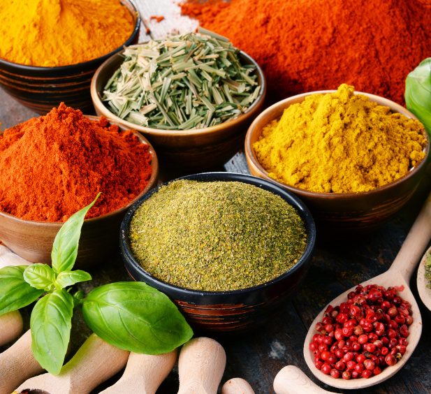 Variety Of Spices And Herbs On Kitchen Table